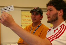 Two men using the blind spot test strip